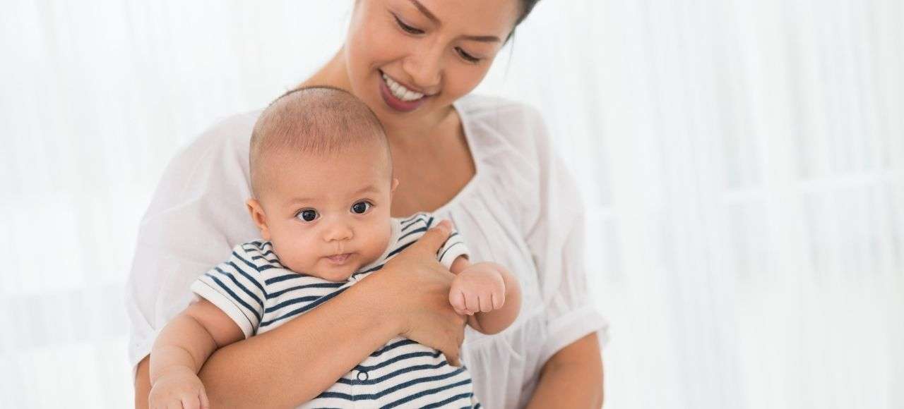 infant being held by mother